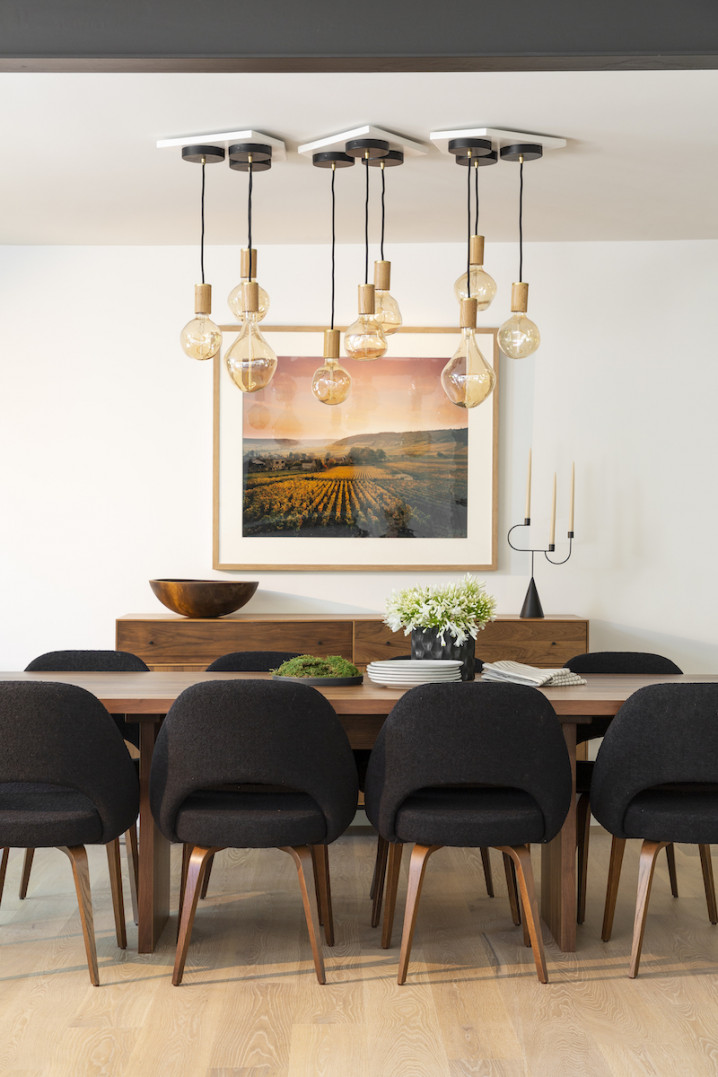 dining-room-interior-design-black-fabric-chairs-hanging-light-bulbs