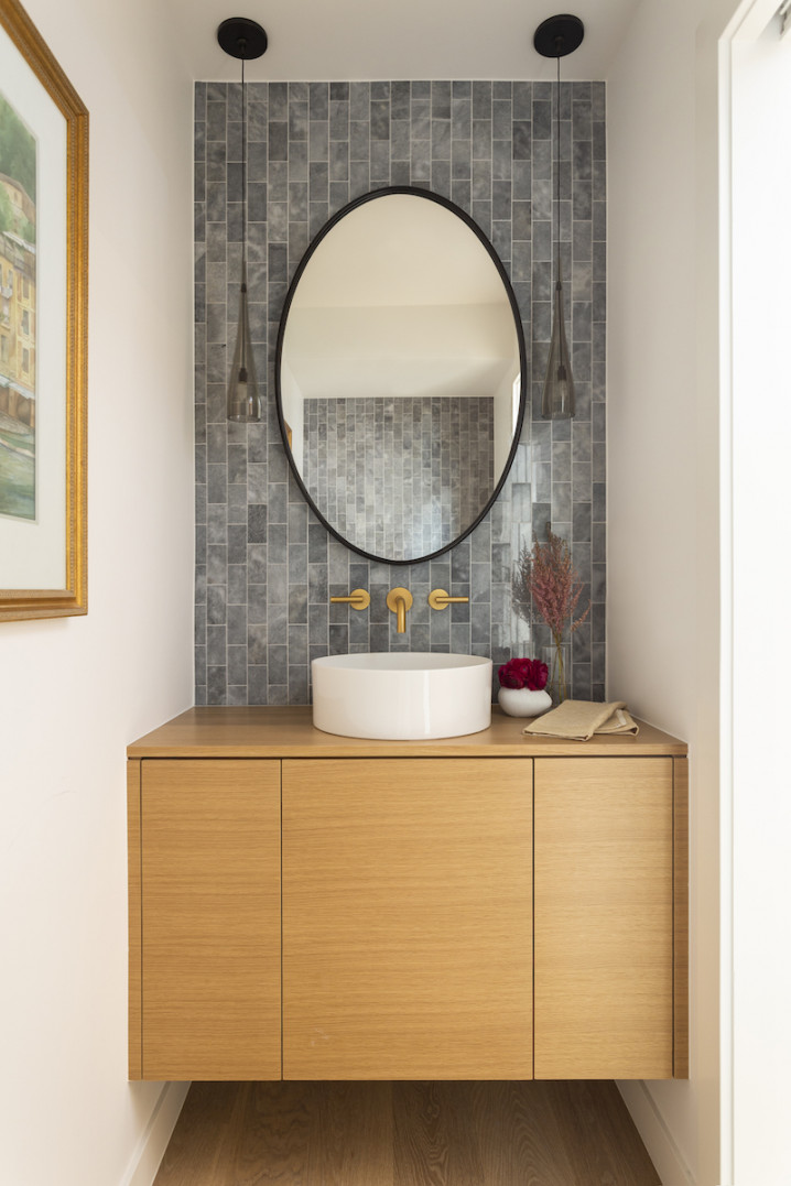 powder-room-interior-design-oval-mirror-tile-backsplash